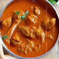 Yellow Gravy Base with rice and garnish on platter