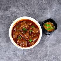 White Onion Paste gravy in bowl with spices around